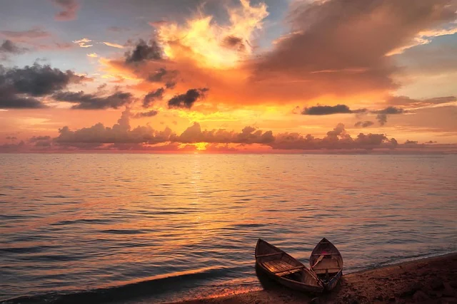 A quiet lake at sunset with a resting canoe